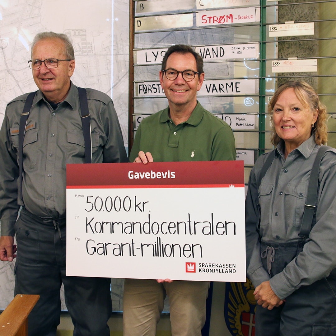 Afdelingsdirektør Jan Nyvang fra Sparekassen Kronjylland overrækker donationen til de frivillige, der holder liv i historien i den gamle koldkrigsbunker.